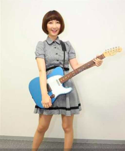 ギターを手にする竹上萌奈